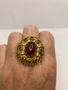 Vintage red carnelian golden bronze ring Lovely vintage golden bronze setting Size 8 My jeweler would re size for $20 fee All rings are shipped in a nice gift box. Check out our over a THOUSAND great reviews Engraving is $4 per letter and is not always perfect depending on the piece. It can take a few days if the jeweler is busy. This is payable to Paypal Judithsltd@gmail.com Antique Jewelry Ring With Antique Finish, Collectible Gold Ruby Rings, Unique Antique Finish Rings As Gift, Gold Ruby Rings For Collectors, Antique Carnelian Cabochon Rings, Vintage Bronze Gemstone Jewelry, Antique Gold Ruby Ring Hallmarked, Bronze Gemstone Vintage Jewelry, Antique Gold Ruby Ring