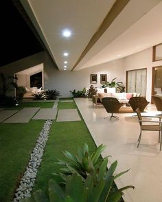 an open living room and dining area with artificial grass