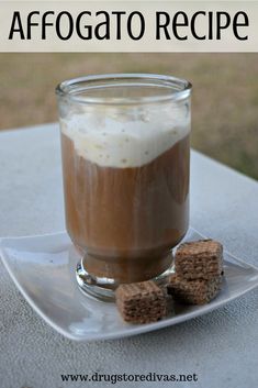 a cup of coffee with marshmallows on a plate