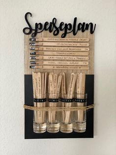 there is a wooden sign that says spersoneplan on it and six glasses in front of it