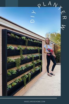 a woman standing next to a wall with plants growing on it and the words diy planter in front of her