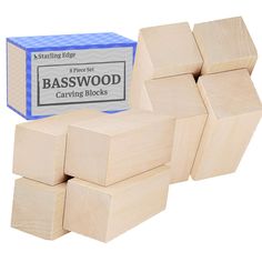 several wooden blocks are stacked on top of each other in front of a blue box