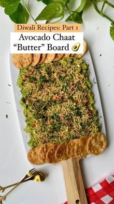 a white plate topped with crackers covered in green and brown toppings next to a red checkered table cloth