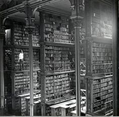 an old library with lots of books in it and a quote on the wall that says, i could spend a life time in this room and not be bored