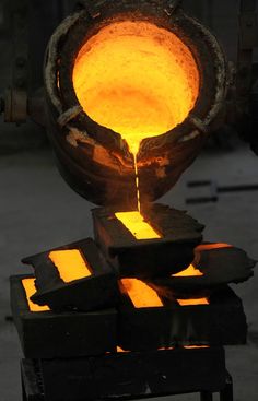 an iron casting machine with bright yellow light coming from it