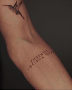 a small tattoo on the arm that says aurumtis tofuna in roman numerals