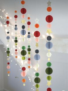 some paper balls and stars hanging from the ceiling