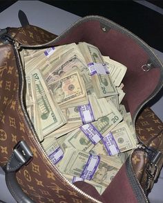 a bag filled with money sitting on top of a table