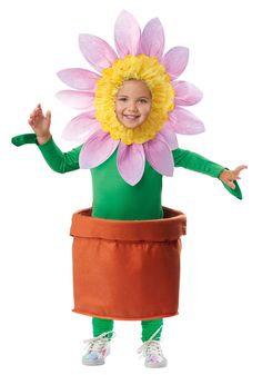 a child wearing a flower costume standing in a pot with his hands out and smiling