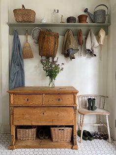 a wooden dresser sitting next to a shelf filled with baskets