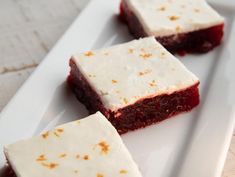 three pieces of red velvet cake on a white plate