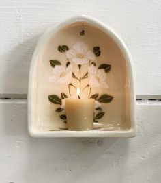 a candle that is sitting inside of a wall