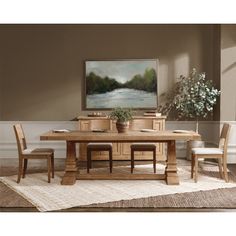 a dining room table with chairs and a painting on the wall