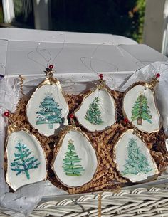 six christmas tree ornaments in a basket