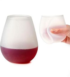 a hand is holding a wine glass with red liquid in it and another one has a white background