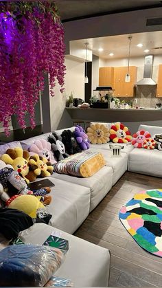 a living room filled with lots of stuffed animals on top of couches and rugs