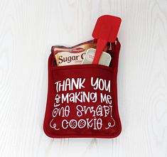 a red bag with some food in it on top of a white table and the words thank you, making me one smart cookie