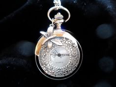 "A stunning silver tone pendant pocket watch necklace with a handmade white flower,  a lovely little dragonfly or bird!  This Vintage Victorian pocket watch will make an adorable gift for women who love nostalgic jewelry, and is also a pretty gift for bridesmaids, and an heirloom to keep, for Christmas, New Year, Valentines Day, Birthday, Wedding, Easter... This romantic pendant watch by ANNALEAS FINEST features a beautiful flower, with a frosted white lucite flower and was created with a Swarov Vintage Silver Pocket Watch For Wedding, Antique Silver Pocket Watch For Anniversary, Elegant Locket Pocket Watch For Gift, Antique Round Pocket Watch Gift, Silver Necklace With Butterfly Clasp For Gift, Silver Vintage Pocket Watch, Silver Vintage Pocket Watch Gift, Vintage Silver Pocket Watch As Gift, Elegant Metal Pocket Watch With Locket