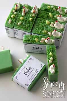 four soap bars with green icing and small white ducks on them, sitting next to each other