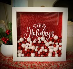 a red and white photo frame with christmas balls in the center, happy holidays written on it