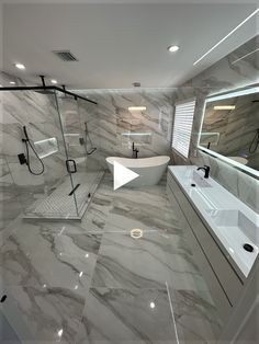 a large bathroom with marble floors and walls