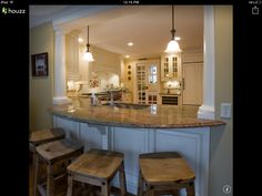 a kitchen with an island and stools in it