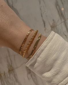 Our Lola necklace is so popular that we decided to release it in a bracelet! The twisted rope chain catches all the light and is made in 18k gold fill. Tarnish-resistant, showerproof, and safe for sensitive skin. …………………………………. D E T A I L S • Rope chain width measures 3mm• Lobster clasp• Tarnish-resistant, waterproof, and safe for sensitive skin • 18K Gold Filled Indian Fits, خواتم خطوبة, Figaro Chain, Jewelry Lookbook, Gold Bracelet Chain, Girly Jewelry, Gold Filled Jewelry, Gold Filled Chain, Pretty Jewellery