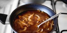 a pot filled with soup sitting on top of a stove