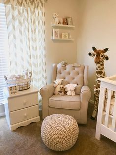 a baby's room with a chair, crib and stuffed giraffe