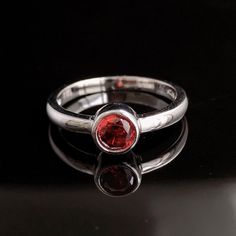 Sterling silver ruby ring set with small white topaz gemstones. It is made of solid British Sterling Silver with rhodium plating.  Rhodium-plated silver is fine sterling silver that is polished and dipped in rhodium. It has a bright finish, similar to white gold items, and it doesn't tarnish. I may not have all sizes ready to ship but it normally takes me about 2-3 days to make if not ready, I will let you know immediately if I need more than 3 days to finish it. Please contact me if you require Modern Sterling Silver Round Birthstone Ring, Modern Silver Diamond Ring With Birthstone, Classic Silver Crystal Ring With Birthstone, Classic Ruby Stackable Rings With Gemstones, Fine Jewelry Red Birthstone Ring With Polished Finish, Classic Ruby Stackable Rings, Modern Sterling Silver Birthstone Ring, Classic Round Ruby Stackable Rings, Modern Ruby Ring For Promise