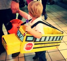 a little boy in a construction truck costume