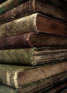 a stack of old books sitting on top of each other