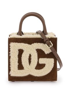 DG Daily tote bag by Dolce & Gabbana made of suede and characterized by shearling DG logo and lining. Interior with one open pocket, one zippered pocket and one logoed card slot. Double top handles and adjustable and removable shoulder strap. Metal hardware with gold finish. Dolce And Gabbana Handbags, Suede Tote Bag, Dg Logo, Suede Tote, Mini Tote Bag, Dolce E Gabbana, Coffee Brown, Mini Tote, See By Chloe