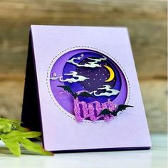 a purple card with bats and the word boo written in it, on top of a table