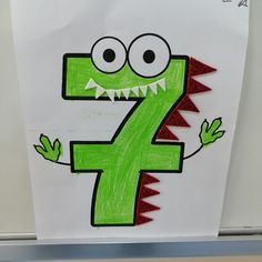 a drawing of a green monster with the number seven drawn on it