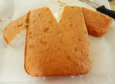 a loaf of bread sitting on top of a white paper bag next to a knife