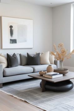 a living room filled with furniture and a painting on the wall above it's coffee table