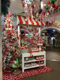 a christmas display with candy canes, candies and other holiday decorations on it