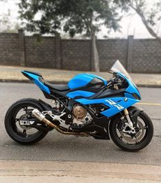 a blue and black motorcycle parked on the street