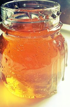 a jar filled with liquid sitting on top of a table