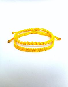 "Yellow macrame bracelets, Twisted and flat knotted Classic macrame friendship bracelets perfect for everyday wear! These handknotted bracelets are made with durable yellow waxed string. They are adjustable and have a sliding knot closure in order to fit a lot of sizes. Due to their waxed threads,the bracelets are very durable and water resistant. Width: 0.4cm / 0.15\" The price is for one bracelet.Or choose the set of 2 to save on shipping! Similar bracelets: https://www.etsy.com/listing/227376 Yellow Friendship Bracelet, Rat Jewellery, Macrame Friendship Bracelets, Yellow Macrame, Movie Outfit, Bts Bracelet, Jewelry Everyday, Sliding Knot Closure, Beach Bracelet