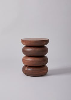 three stacked wooden bowls on top of each other in front of a white background,