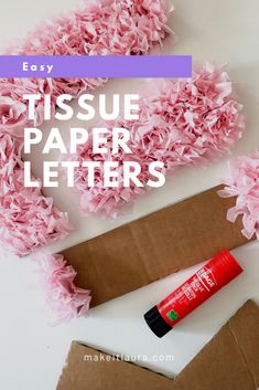 tissue paper letters and some pink flowers on a white surface with the words easy tissue paper letters