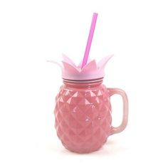 a pink pineapple shaped glass mug with a straw sticking out of the top, on a white background