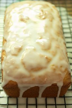 a loaf of glazed bread sitting on top of a cooling rack