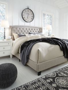 a bedroom with white furniture and black rugs