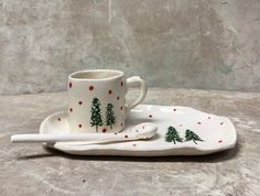 a cup and saucer with trees on them