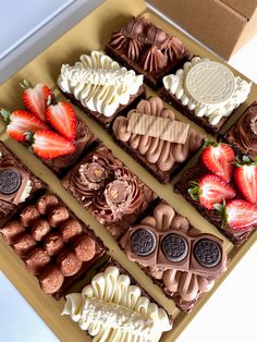 chocolates and strawberries are arranged on top of each other in an open box