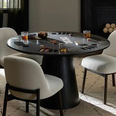 a black table with white chairs around it