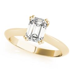 an emerald - cut diamond ring in yellow gold